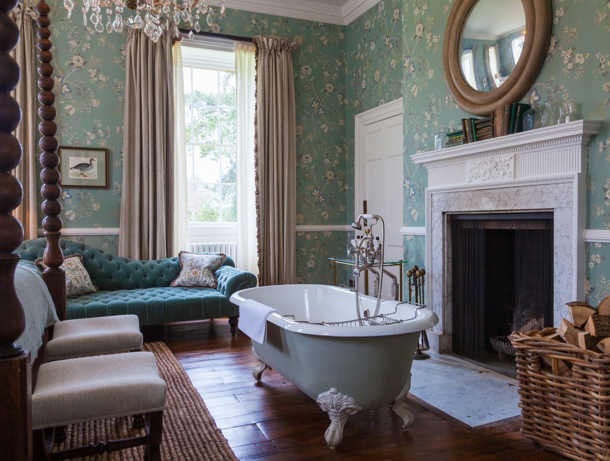 Tufted Chaise Lounge and clawfoot bathtub in English country bathroom design at Babington House