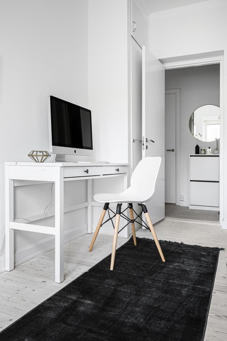 White Shell Chair in Scandinavian Office with Dark Gray Rug via vaningen.se