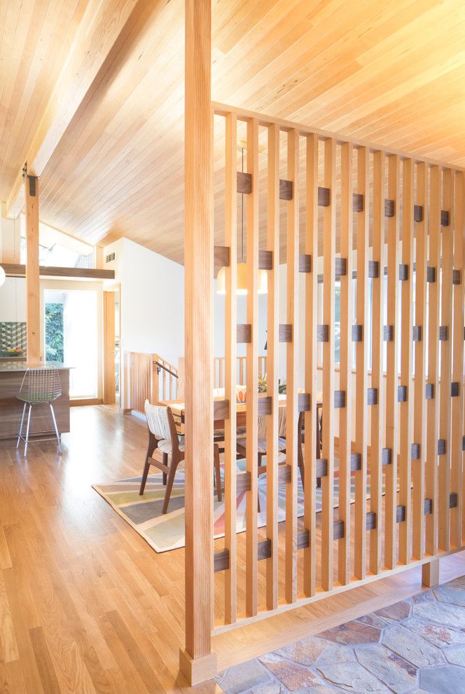 Wood Paneling in Mid-century Modern Entryway via The Artisans Group