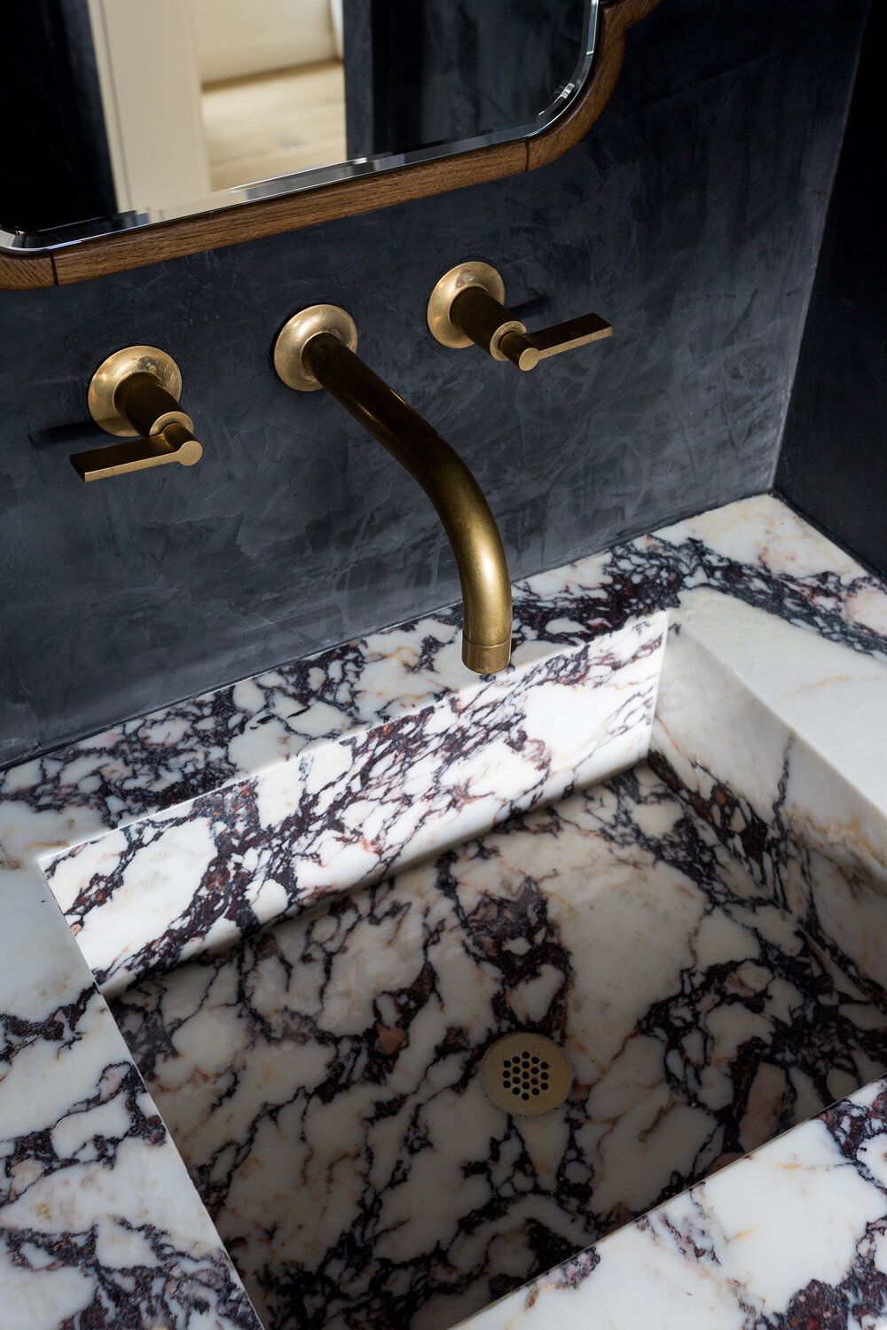 Black walls bathroom with marble sink Aker Interiors