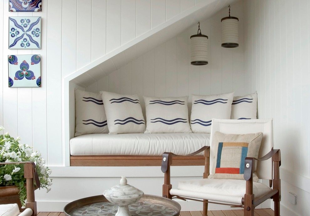 Coastal reading nook under staircase via Sara Bengur Interiors