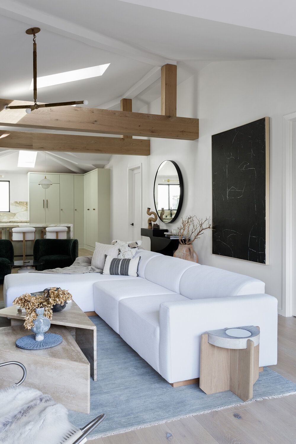 Contemporary neutral living room with white sectional sofa via Aker Interiors