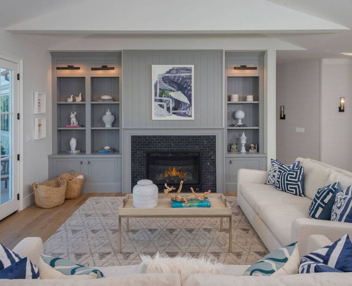 Martha's Vineyard Nautical Living Room Decor with Faded Blue Built-in Bookshelves via Red Door Homes