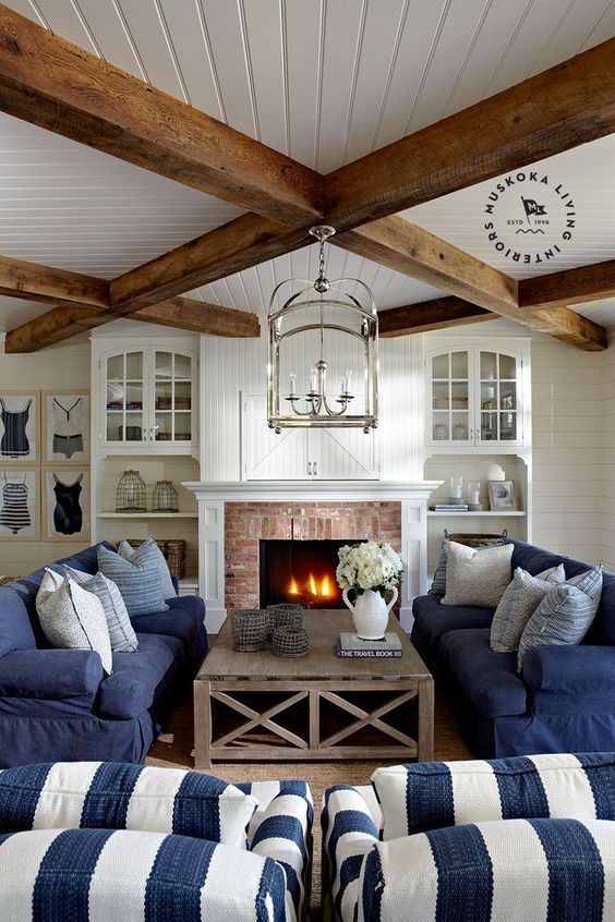 Nautical Living Room with wood ceiling beams, blue striped accent chairs via Muskoka Living Interiors