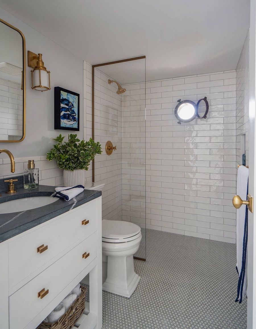 Nautical bathroom design port hole window shower via Shor Home