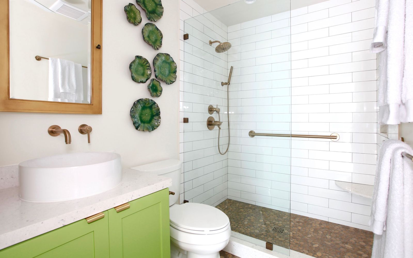 There's No Shortage Of Fun In This Tropical Modern Delray Oasis bathroom  with green tile shower, black iron frames and white sink on wood vanity -  Luxe Interiors + Design