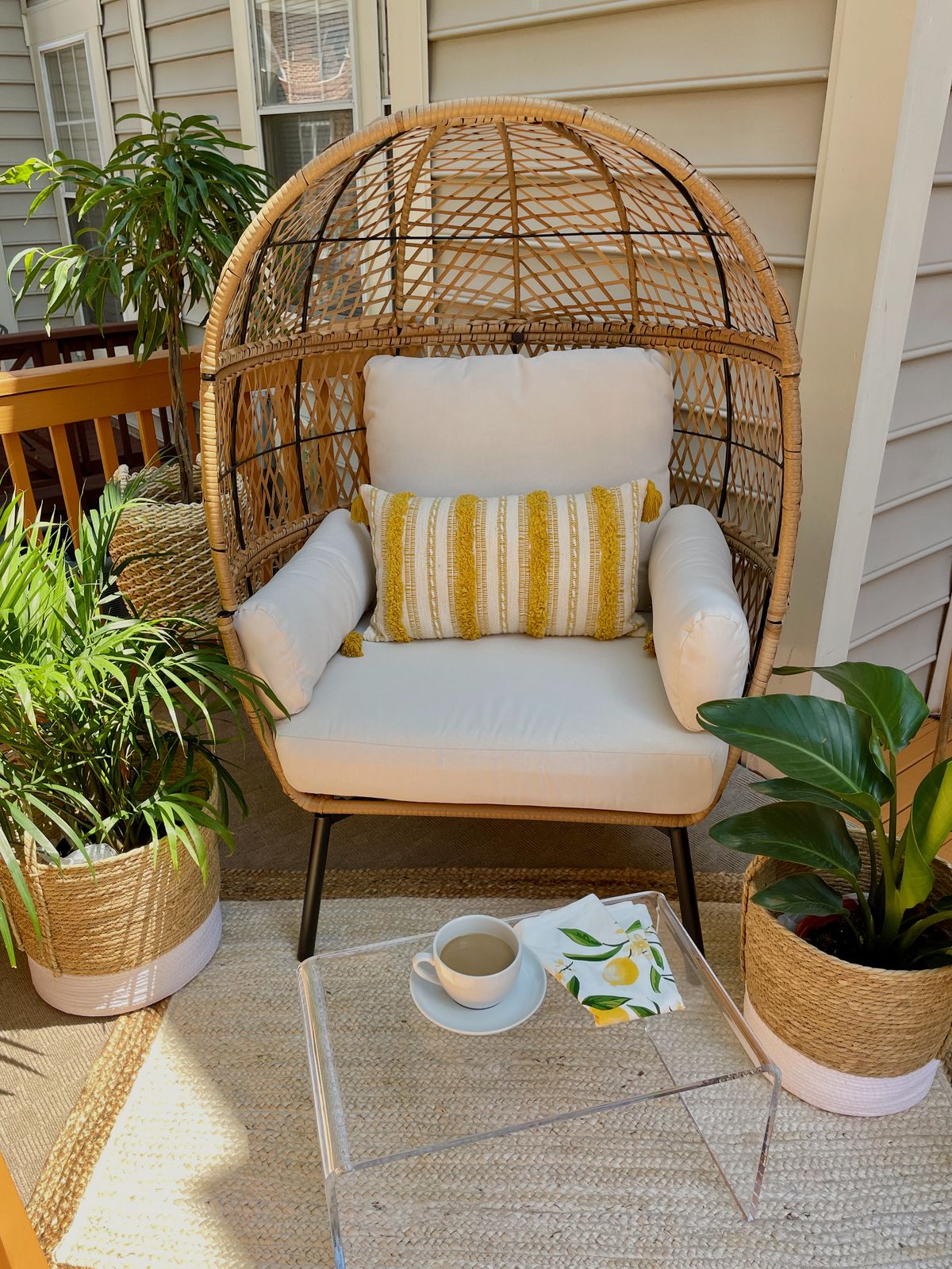 Yellow Citrus Summer Patio Decor Update with Egg Chair, Yellow Pillow, acrylic table, jute rug, jute planters, majestic palm and lemon cloth napkins from Walmart