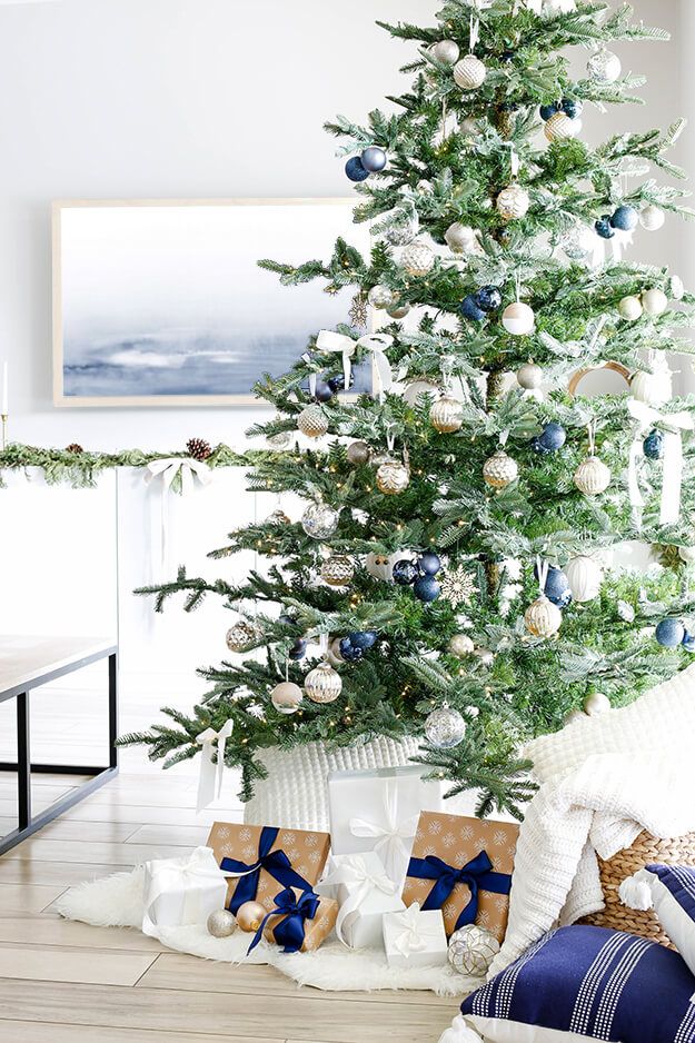 Blue ribbon around presents christmas decor via yourmarketingbff