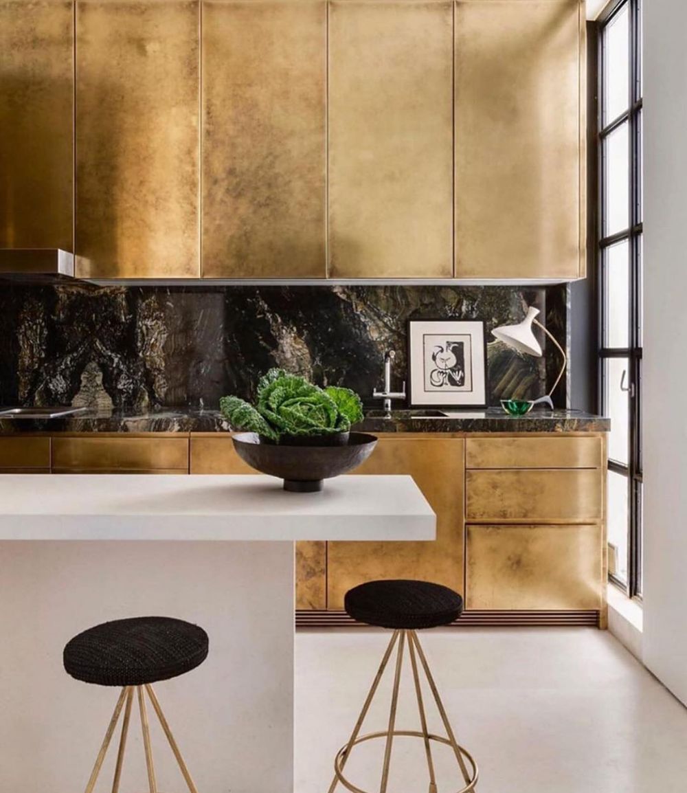 Brass kitchen cabinets with black marble @jaimeberiestainstudio