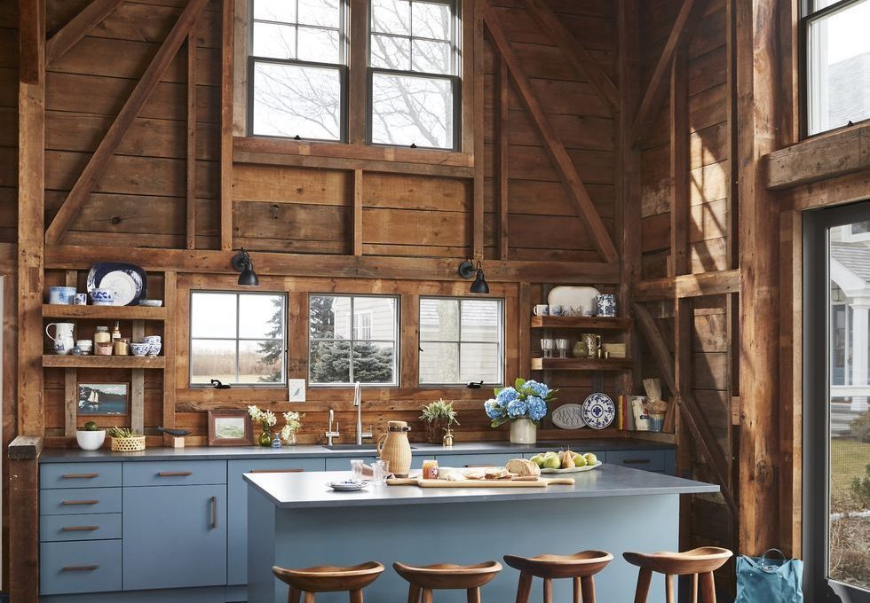 Rustic Kitchen with Blue Cabinets and Exposed Wood Walls via Designer Hadley Wiggins-Marin