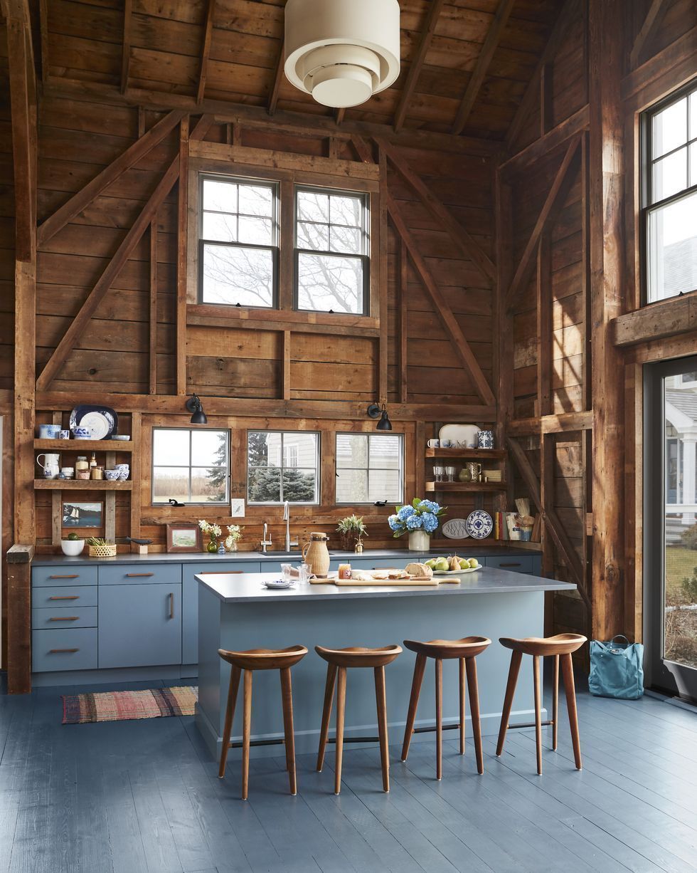 Rustic Kitchen with Blue Cabinets and Exposed Wood Walls via Designer Hadley Wiggins-Marin