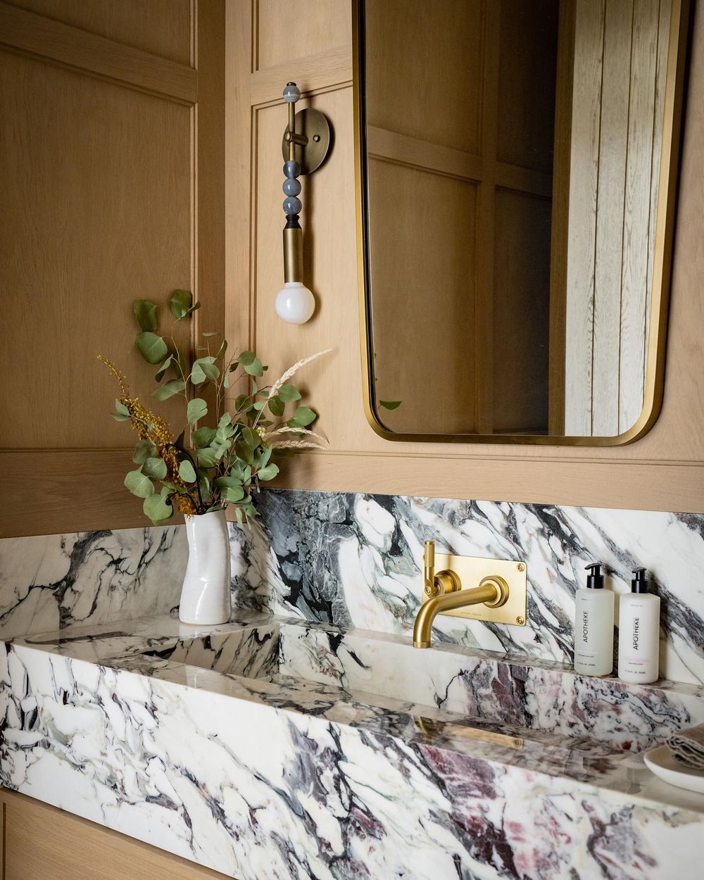 Marble bathroom countertops brass wall mount faucet @laurabrophyinteriors