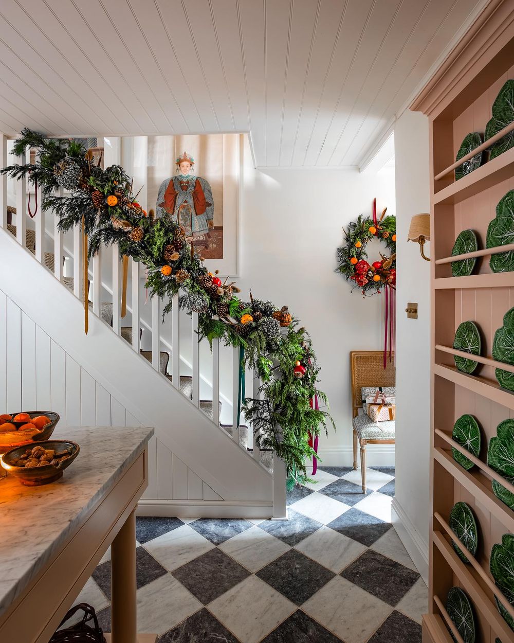 English country christmas decor evergreen garland with oranges on staircase bannister seansymington