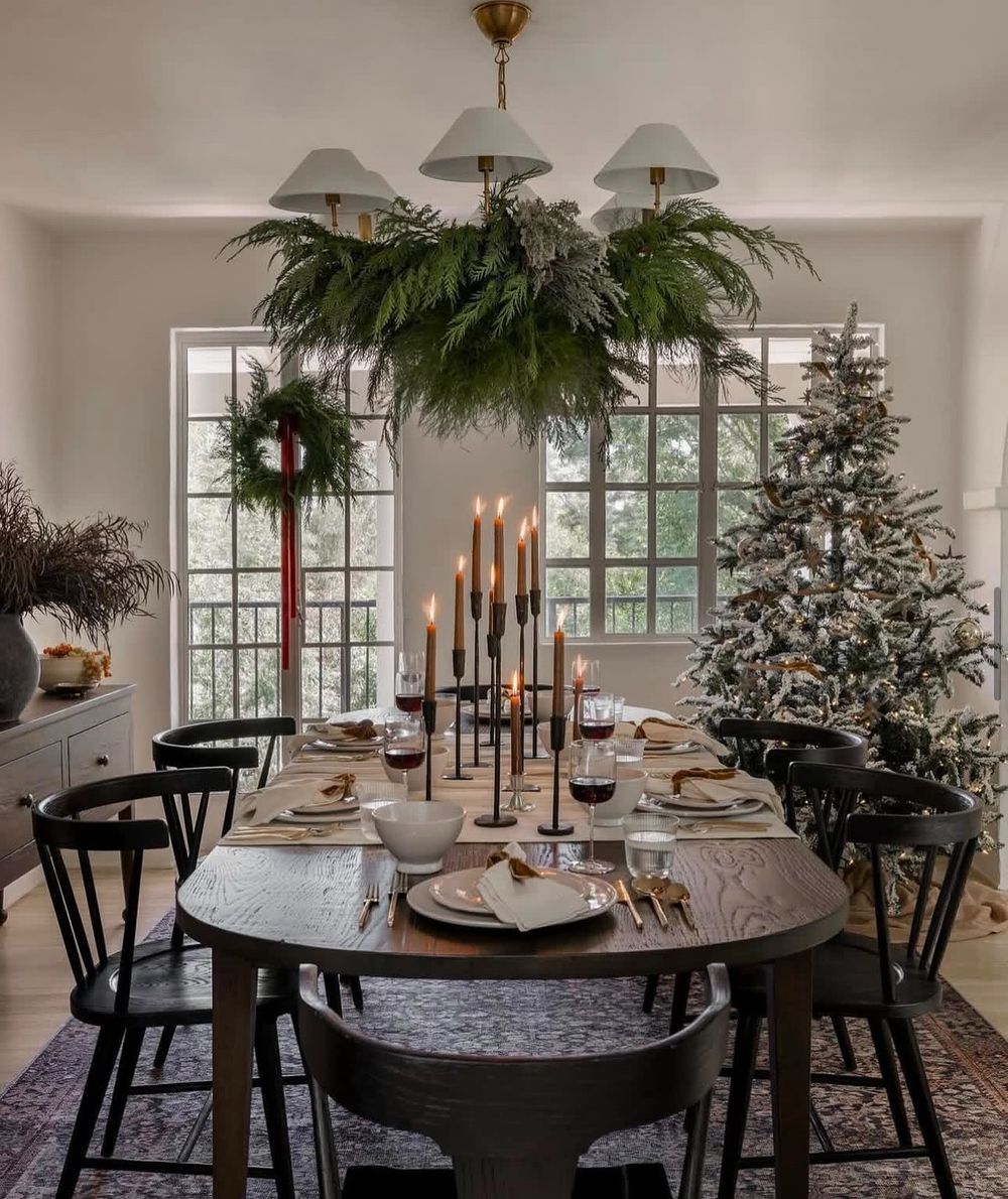 Modern Christmas Decor Garland on dining room chandelier @amberinteriors