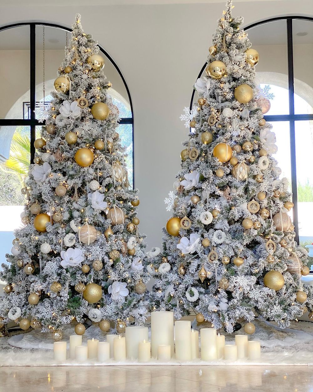 Two frosted Christmas trees with gold ornaments rbitalia