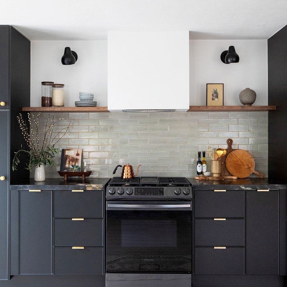 black kitchen with sage green tile backsplash citysage