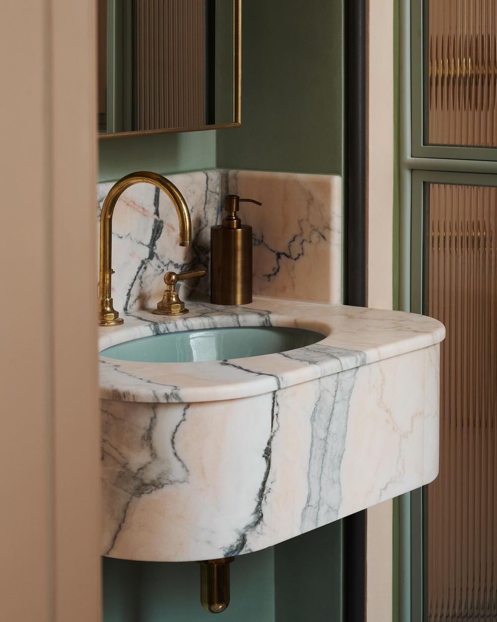 pink marble bathroom vanity with brass faucet madduxcreative