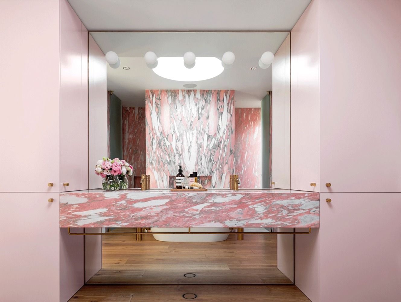 pink marble built in bathroom vanity via archdaily