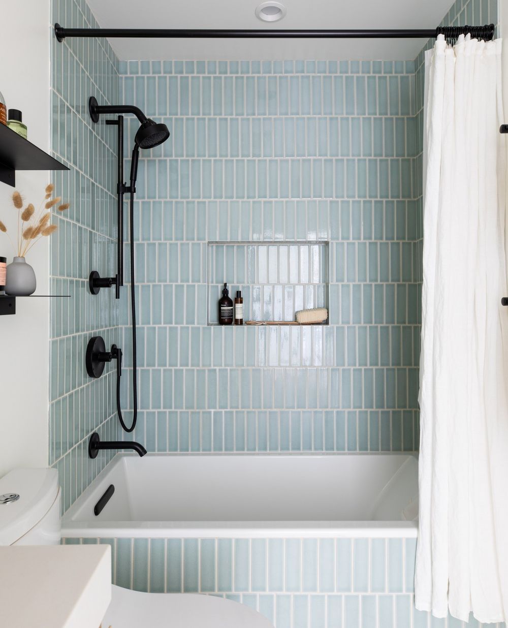 shower niche in blue tile bathroom cathiehonginteriors