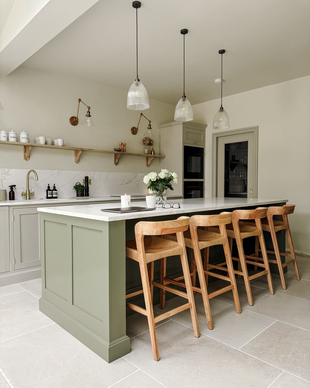 Kitchen island with wood seating sage green paint @ginandinteriors