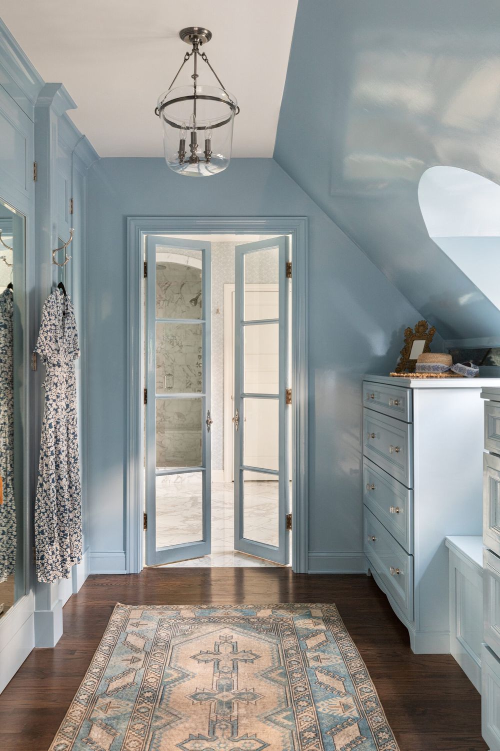 Slanted ceiling blue walls dresser underneath Alexandra Kaehler Design